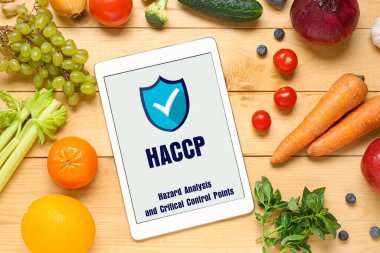 VEGAN GÜNÜ yazılı tablet bilgisayarı, ahşap zemin üzerinde taze sebzeler ve meyveler