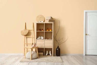 Rafların, merdivenlerin, kapıların ve şık ayakkabıların bulunduğu hafif bir butiğin içinde.