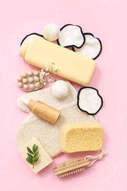 Farklı banyo malzemelerine ve pembe arka planda kozmetik ürünlere sahip kompozisyon