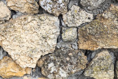 Arka plan olarak yıpranmış taşların dokusu, yakın plan