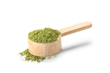 Beyaz arka planda pudralanmış kibrit çayı ile ahşap kepçe.