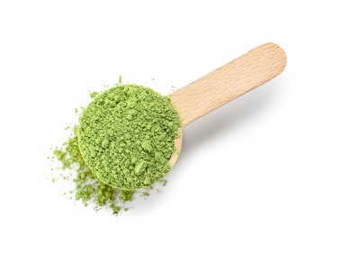 Beyaz arka planda pudralanmış kibrit çayı ile ahşap kepçe.