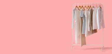 Pembe arkaplandaki şık kıyafetlerle metin için yer aç