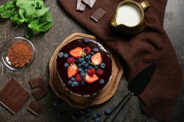 Lezzetli çikolatalı pasta, taze böğürtlen, nane ve grunge siyah arka planda malzemeler.