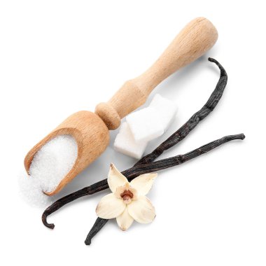 Vanilya şekerli kepçe, çiçek ve beyaz arka planda çubuklar