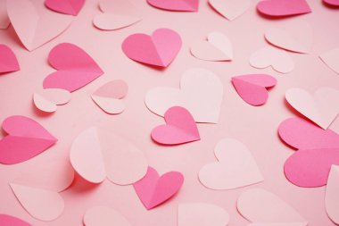 Paper hearts on pink background. Valentine's Day celebration