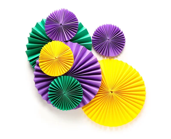 Composition with colorful paper fans on white background. Celebration of Mardi Gras