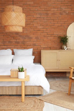 Şık bir yatak odası, rahat bir yatak odası, ahşap bir dolap ve ev bitkileri.