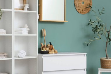 Masaj vücut fırçaları, ahşap toplar ve odanın içinde kozmetik ürünler bulunan çekmeceler.