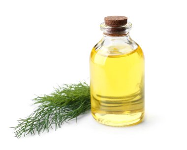 Beyaz arka planda bir şişe dereotu tohumu.