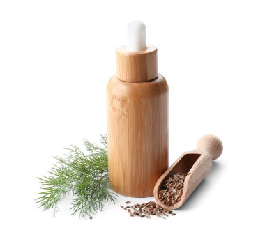 Beyaz arka planda bir şişe dereotu tohumu.