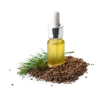 Beyaz arka planda bir şişe dereotu tohumu.