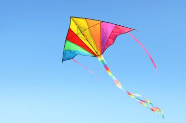 Mavi arka planda uçan güzel renkli uçurtma