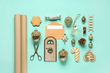 Noel topları, zarf, makas ve nane arkaplanı üzerine paket kağıdı içeren kompozisyon