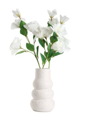 Vase with artificial eustoma flowers on white background
