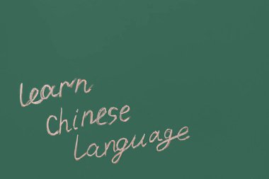 Text LEARN CHINESE LANGUAGE on green chalkboard
