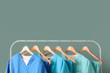 Yeşil arka planda tıbbi üniformalı adam.