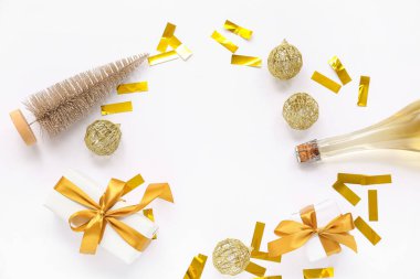 Frame made of golden Christmas balls, confetti, bottle of champagne and gift boxes on white background