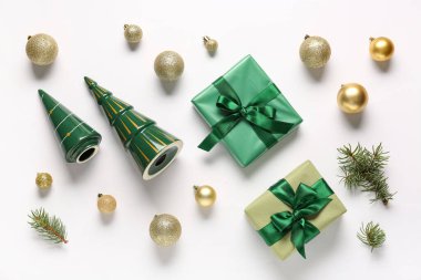 Composition with gift boxes and golden Christmas balls on white background