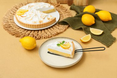 Plate with piece of tasty lemon pie on beige grunge table