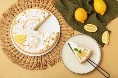 Plate with tasty lemon pie on beige grunge background, closeup