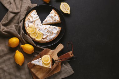 Composition with tasty lemon pie on black grunge background
