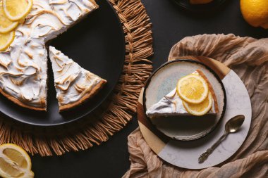 Composition with tasty lemon pie on black grunge background, closeup