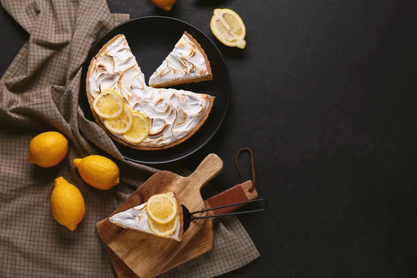 Composition with tasty lemon pie on black grunge background