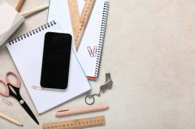 Gri grunge arkaplan üzerinde cep telefonu, kırtasiye ve modern flaş bellek bileşimi