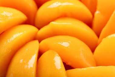 Texture of sweet canned peaches as background