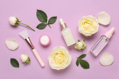 Beautiful white rose flowers and different cosmetic products on lilac background