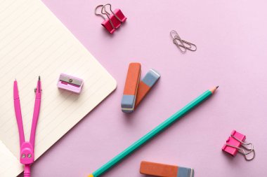 Leylak arkaplanında defter, kalem ve pusula olan silgi