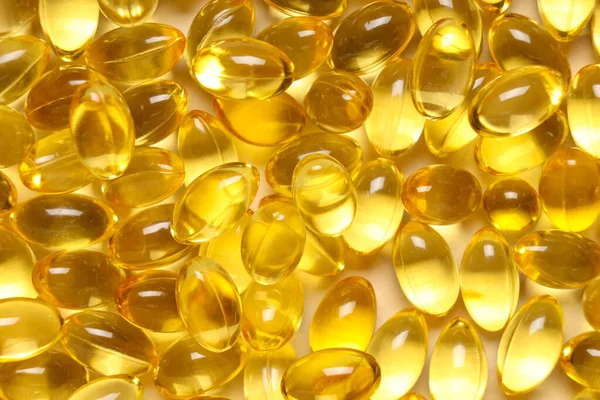 Bej arka planda E vitamini kapsüllerinin dokusu