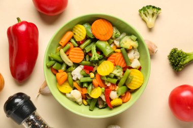 Bowl of stewed mixed vegetables on beige background