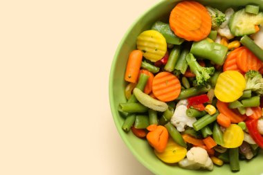 Bowl of stewed mixed vegetables on beige background
