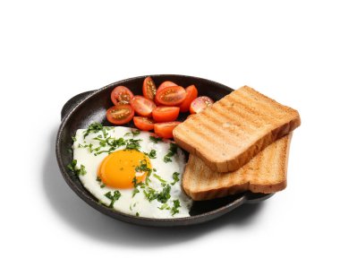 Frying pan with tasty fried egg, tomatoes, parsley and toasts on white background