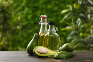 Dışarıdaki ahşap masada taze avokado yağı ve sürahi.