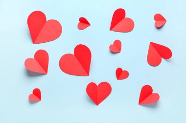 Mavi arka planda kırmızı kağıt kalpler. Sevgililer Günü kutlaması