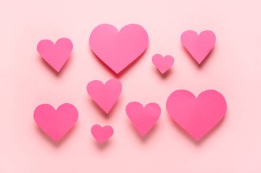 Paper hearts on pink background. Valentine's Day celebration