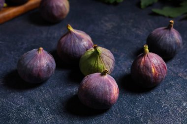 Fresh ripe figs on dark background, closeup