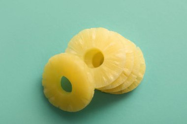 Turkuaz arka planda konserve ananas halkaları