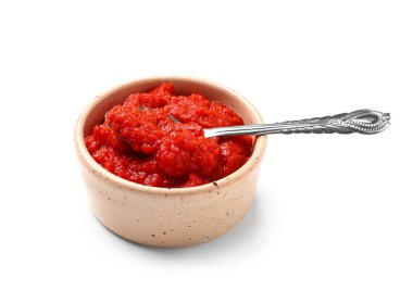 Beyaz arka planda bir kase lezzetli domates ezmesi.