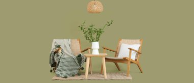 Vazoda bambu saplı masa, yeşil arka planda ahşap koltuklar ve tavan lambası.