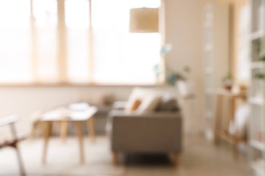 Gri kanepeli, masalı ve pencereli şık oturma odasının bulanık görüntüsü