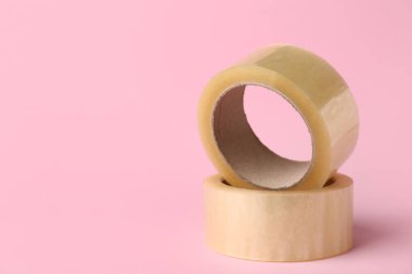 Pembe arka planda yapışkan bant ruloları