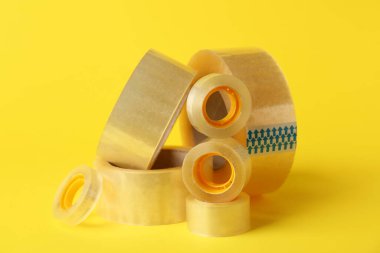 Sarı arka planda birçok yapışkan bant ruloları