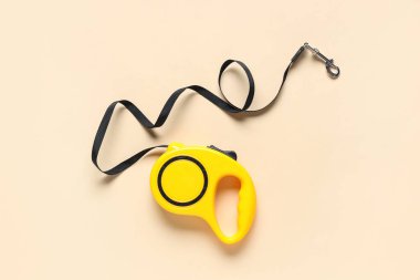Retractable dog leash on beige background