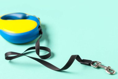 Retractable dog leash on blue background, closeup
