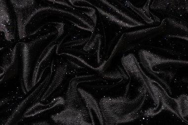 Arkaplan olarak siyah parıltılı kadife kumaş dokusu