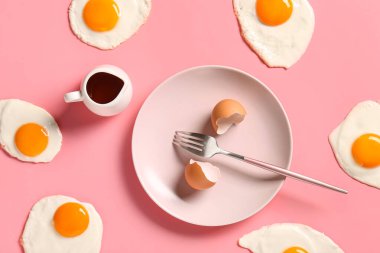 Kabuklu tabak ve pembe arka planda lezzetli kızarmış yumurta.